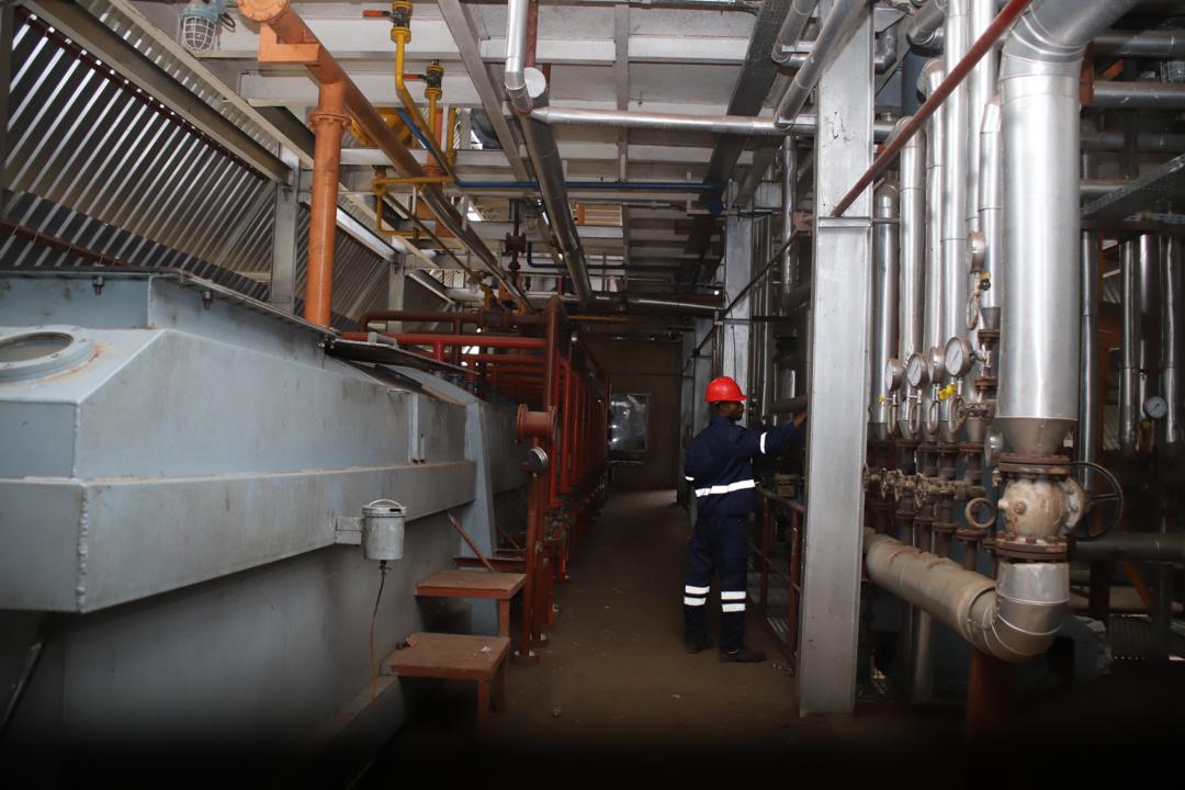 Topcell operator inspecting refinery equipment